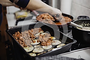 Greek dish in a baking tray standing on the stove