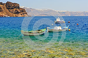 Greek fishing boats at aquamarine transparent sea