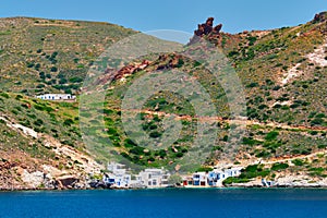 Greek fishing village with traditional whitewashed white houses on Milos island