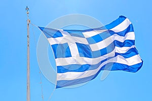 Greek flag against blue sky