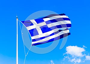 Greek flag against Greek sky