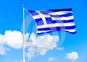 Greek flag against Greek sky