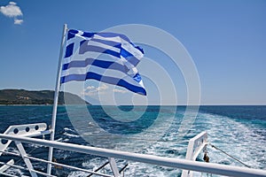 Greek flag on board a cruise boat travelling along Mount Athos Monasteries from Ouranoupolis port, Halkidiki, Greece