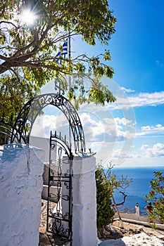 Greek flag and Entrance to Tsambika Monastery, RHODES, GREECE