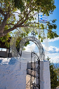 Greek flag and Entrance to Tsambika Monastery, RHODES, GREECE