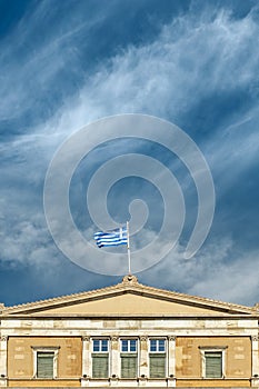 Greek flag on the greek parliament by blue sky