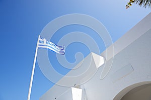 The Greek flag and hotel building, Santorini island
