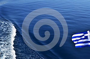 Greek flag over sea waters