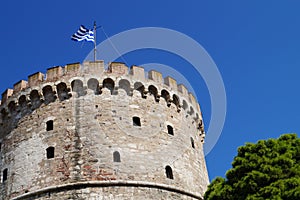 Greek flag on the roof of the wthite tower of thessaloniki photo