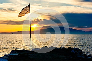 Greek flag, seashore, sunset