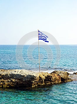 Greek flag on a small rocky island