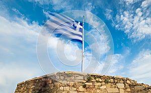 Greek flag waving against blue sky
