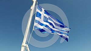 Greek flag waving in slow motion on a greek ship ,