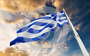 Greek flag waving at sunset