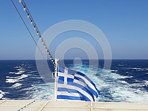 Greek flag on the wind in a moving boat.