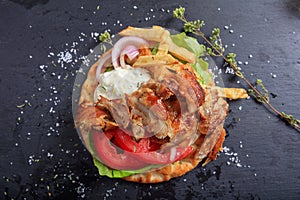 Greek gyros dish on a black dish - top view