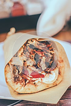 Greek gyros pita with chopped meat, onion and tzatziki sauce