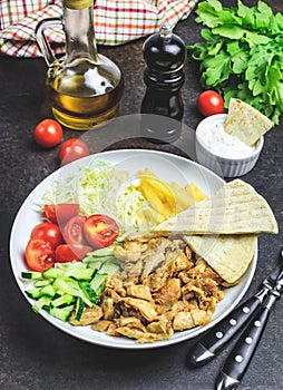 Greek gyros platter with french fries and vegetables