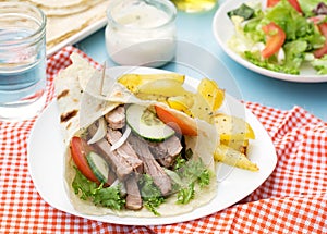 Greek gyros with pork, vegetables and homemade pita bread