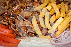 Greek gyros, souvlaki,meat, fried potatoes, tomatoes and onions, Athens Greece, national food, traditional Greek cuisine