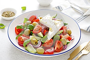 Greek or horiatiki salad with fresh vegetables and feta cheese, dressed with olive oil, traditional Greek cuisine salad photo