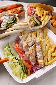 Greek kalamaki and pita gyros with grilled meat served for take away in a fast food restaurant