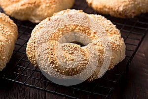 Greek koulouri or Turkish bagels called Simit in stack. Traditional street food, crispy sesame bread ring bagels