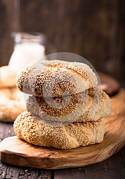 Greek koulouri or Turkish bagels called Simit in stack. Traditional street food, crispy sesame bread ring bagels