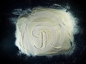 Greek letter pi written on the white sand with black background