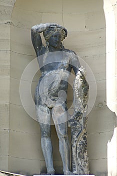 Greek man statue in an alcove, England