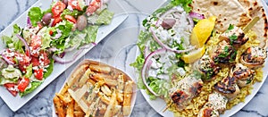 Greek meal with chicken souvlaki, fries and salad