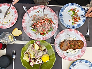 Greek mezedes and traditional salads on a table, Mediterranean food, top view