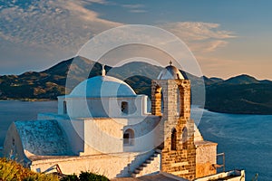 Greek Orthodox church in Plaka village on Milos island on sunset in Greece