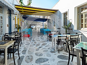 Greek outdoors tavern restaurant with awning at Tinos island, Chora town, Cyclades Greece