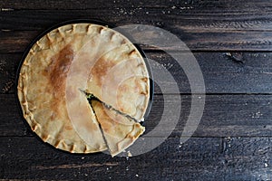 Greek Pie Spanakopita with Spinach and Cheese, top view, copy space.