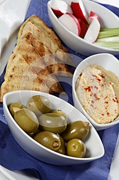 Greek platter with olives vegetables and toast