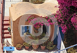 Greek red building with patio and flowers, Santorini island, Gr