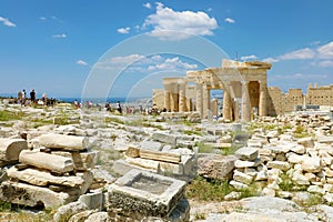 Greek ruins on the Acropolis, Athens, Greece. Unidentified people walking through Propylaea on the Acropolis in a sunny day