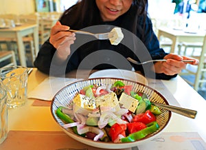 Greek salad bowl with fresh vegetables and feta cheese-which woman eating Healthy diet food concept