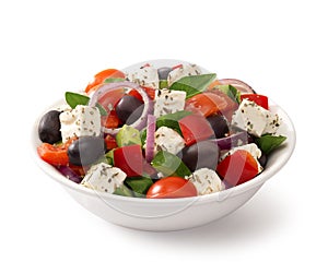 Greek salad in a bowl, isolated on white