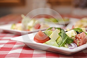 Greek salad with cheese, juicy tomatoes, red pepper, red onion, cucumber and lettuce