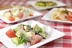 Greek salad with cheese, juicy tomatoes, red pepper, red onion, cucumber and lettuce