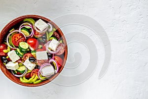 Greek salad on a concrete background. Tomatoes, peppers, olives, cheese, onions. Healthy eating. Diet. Vegetarian food