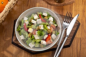 Greek salad with feta cheese, organic olives, juicy tomatoes, red pepper, red onion, cucumber and lettuce