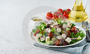 Greek Salad with feta and tomatoes, dieting food on white background copy space closeup