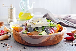 Greek salad of fresh cucumber, tomato, sweet pepper, lettuce, red onion, feta cheese and olives with olive oil. Healthy food, top