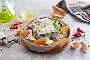 Greek salad of fresh cucumber, tomato, sweet pepper, lettuce, red onion, feta cheese and olives with olive oil. Healthy food, top