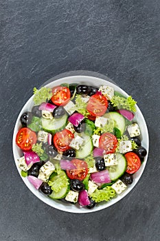 Greek salad with fresh tomatoes olives and feta cheese healthy eating food from above portrait format with copyspace copy space on