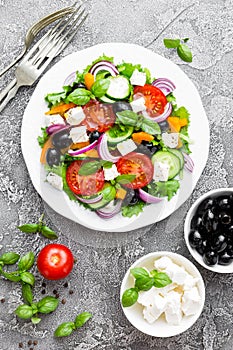 Greek salad. Fresh vegetable salad with tomato, onion, cucumbers, basil, pepper, olives, lettuce and feta cheese. Greek salad on p