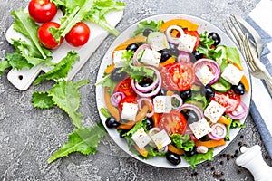 Greek salad. Fresh vegetable salad with tomato, onion, cucumbers, basil, pepper, olives, lettuce and feta cheese. Greek salad on p